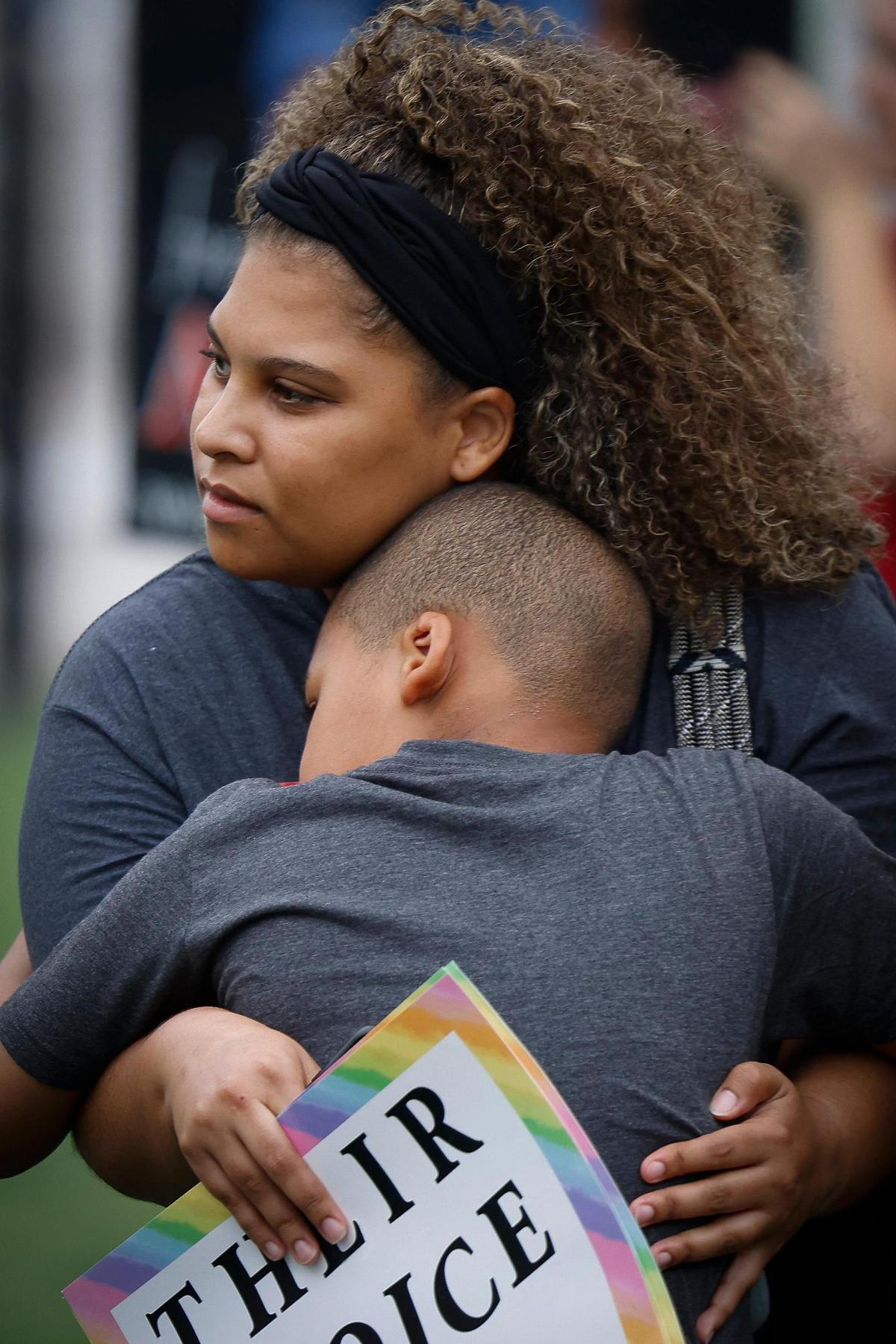 Alysha Stowe, hugs her son Grayson Stowe, 9, both of Gastonia, N.C., during an abortion rights rally at First Ward Park in Charlotte, Sunday, July 10, 2022.