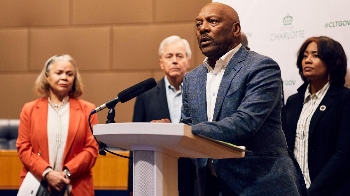 Charlotte City Attorney Anthony Fox stands at the podium defending the closed doors session while lambasting the City Council Member who made remarks in the public about the settlement. The Charlotte City Council members watch on in support of the Mayor and Police Chief after defending remarks made by their colleague City Councilwoman at-large Victoria Watlington in the press.