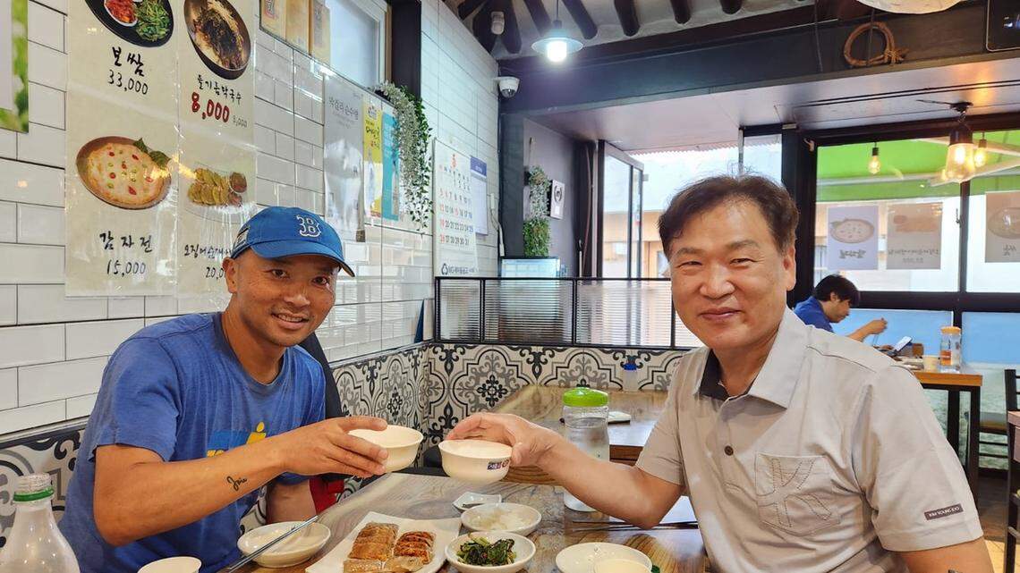 Théoden Janes shares food and drinks with Mr. Shin, co-owner of the guesthouse he stayed at while visiting Seoul last month.