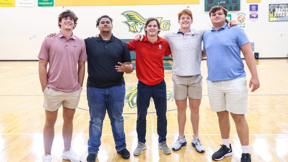 From left, Charlotte Catholic football players Sean Boyle, Gavin Hood, Assistant Coach Matt Rilley, Jack Larson and Clint Barlow during the Southwestern 4A conference media day at Independence High School on Thursday, July 28, 2022 in Charlotte, NC.