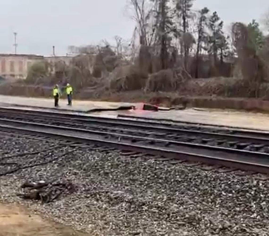 A massive sinkhole submerged a driver’s pickup truck in water nearly up to its windows on a North Carolina road Saturday morning, police said.  