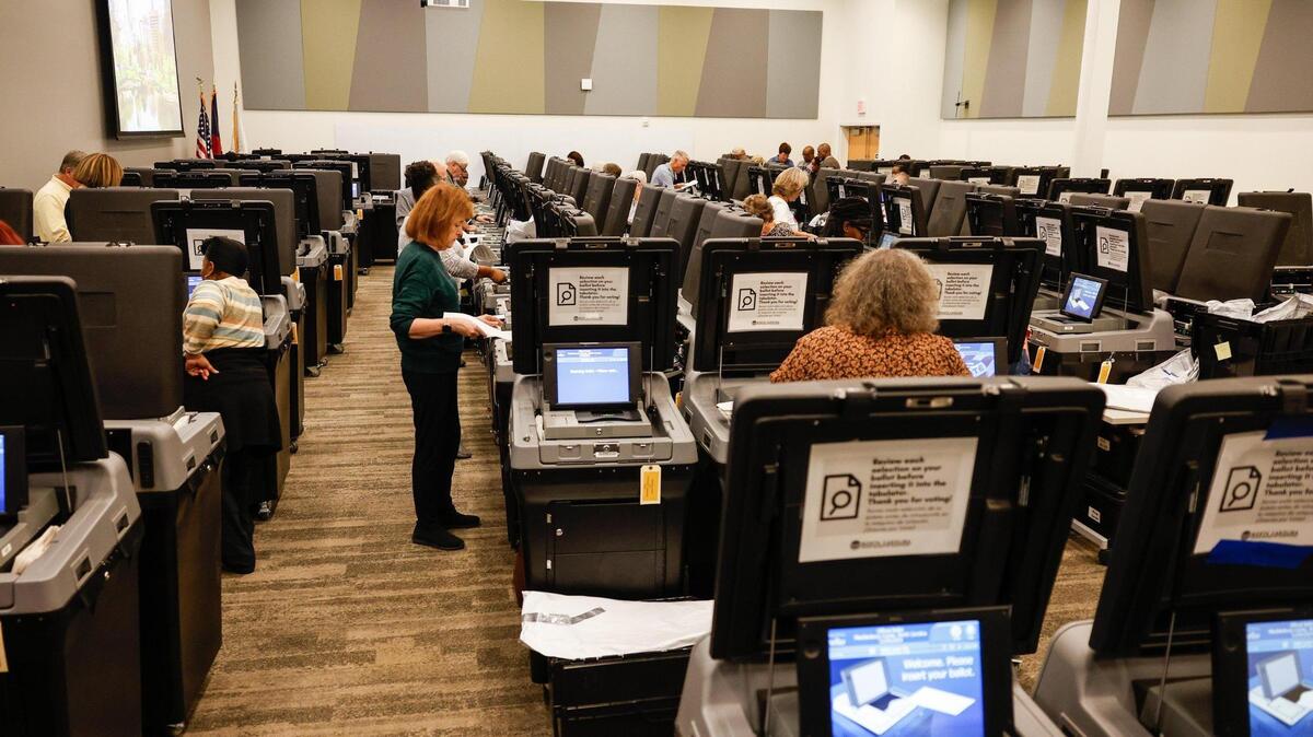 Volunteers feed ballots into ballot machines as Mecklenburg officials hold a recount in NC Supreme Court race, Tricia Cotham’s win over Nicole Sidman, and Woodson Bradley’s win over Stacie McGinn, at Valerie C. Woodard Community Resource Center in Charlotte, NC on Thursday, November 21, 2024.