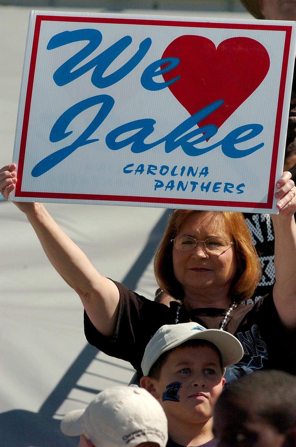 A fan holds up a sign in 2004 professing the supporters’ love of Jake Delhomme.