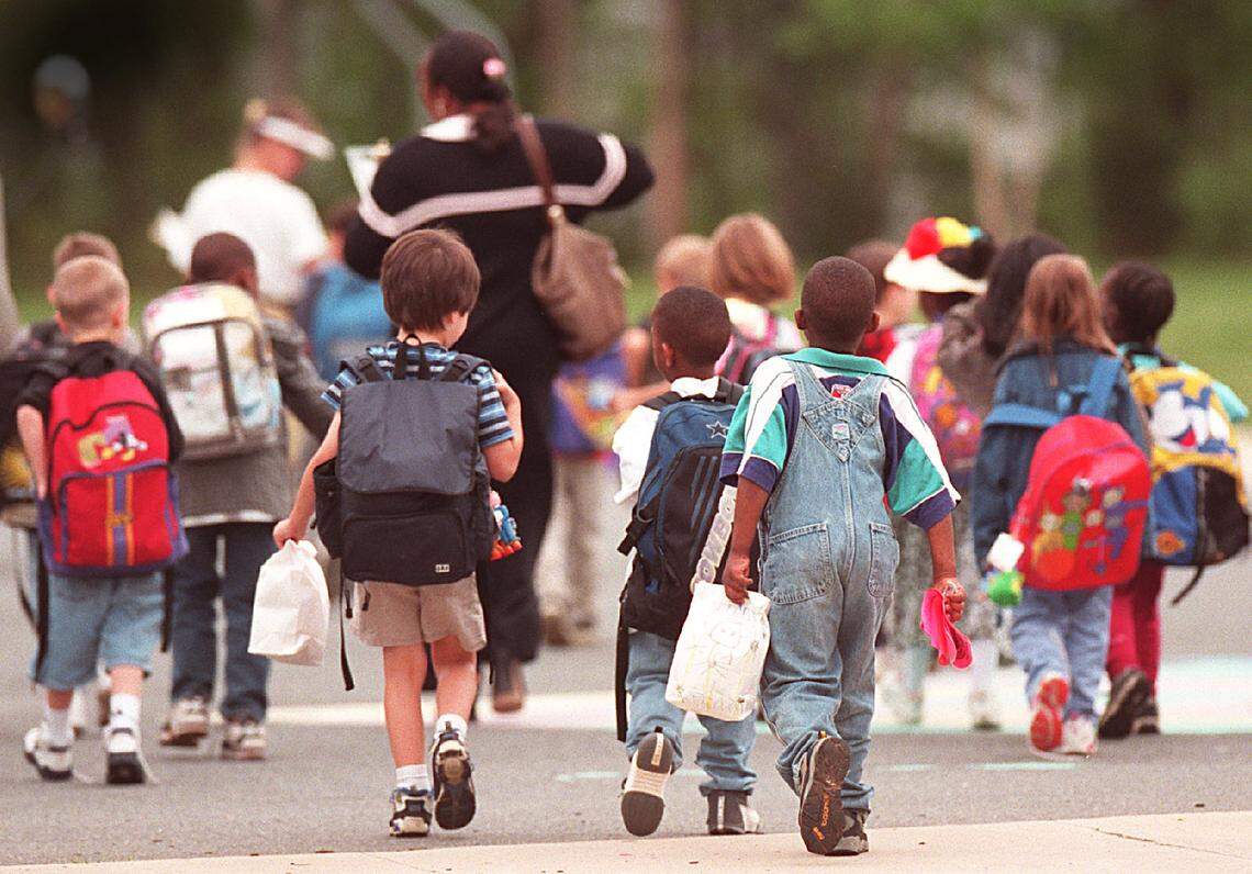 Children prepare to board the school buses at Smithfield Elementary School in a file photo in 2000.