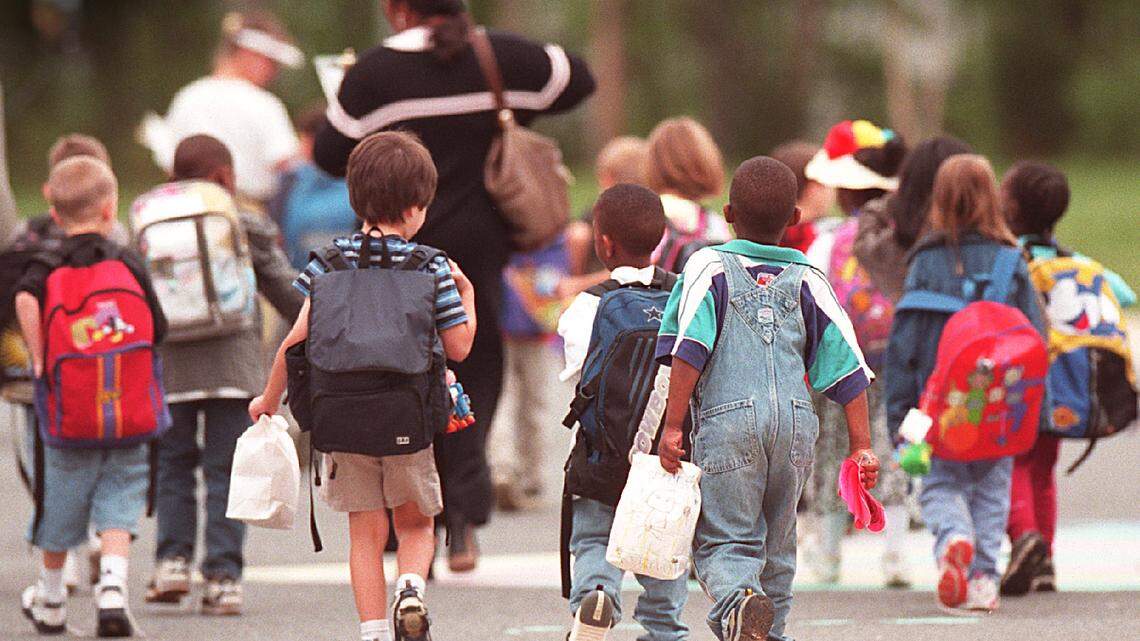 Children prepare to board the school buses at Smithfield Elementary School in a file photo in 2000.