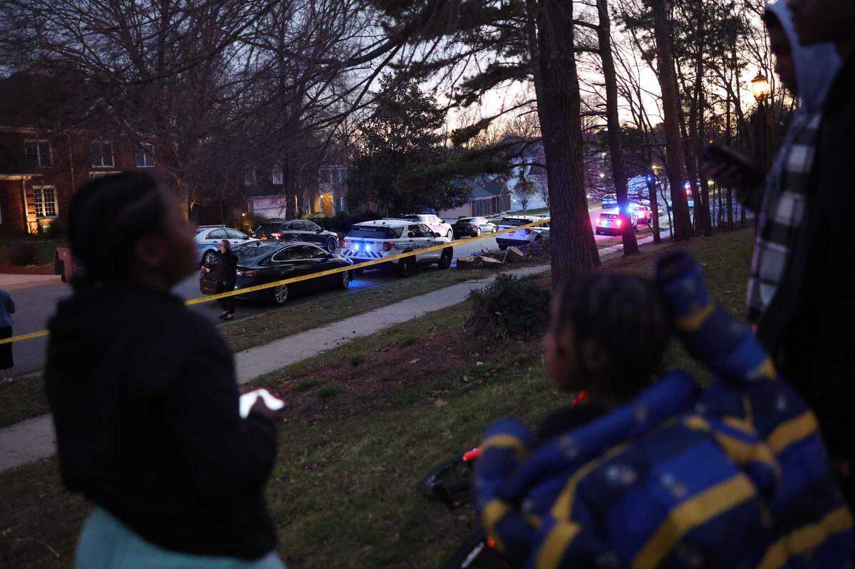 Charlotte-Mecklenburg police officers at the scene where two officers were injured in a shooting in northeast Charlotte on Friday evening.