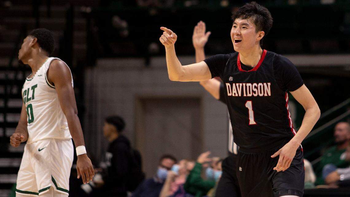 Davidson’s Hyunjung Lee (1) points to the bench after beating the shot clock and sinking a 3-pointer against Charlotte in a 75-58 win Tuesday. Lee scored a career-high 32 points.