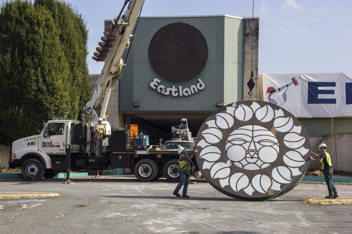 The final “Rising Sun” signage at Eastland Mall being removed and prepared for transport to a storage facility in Concord as it awaits future installation as public art.