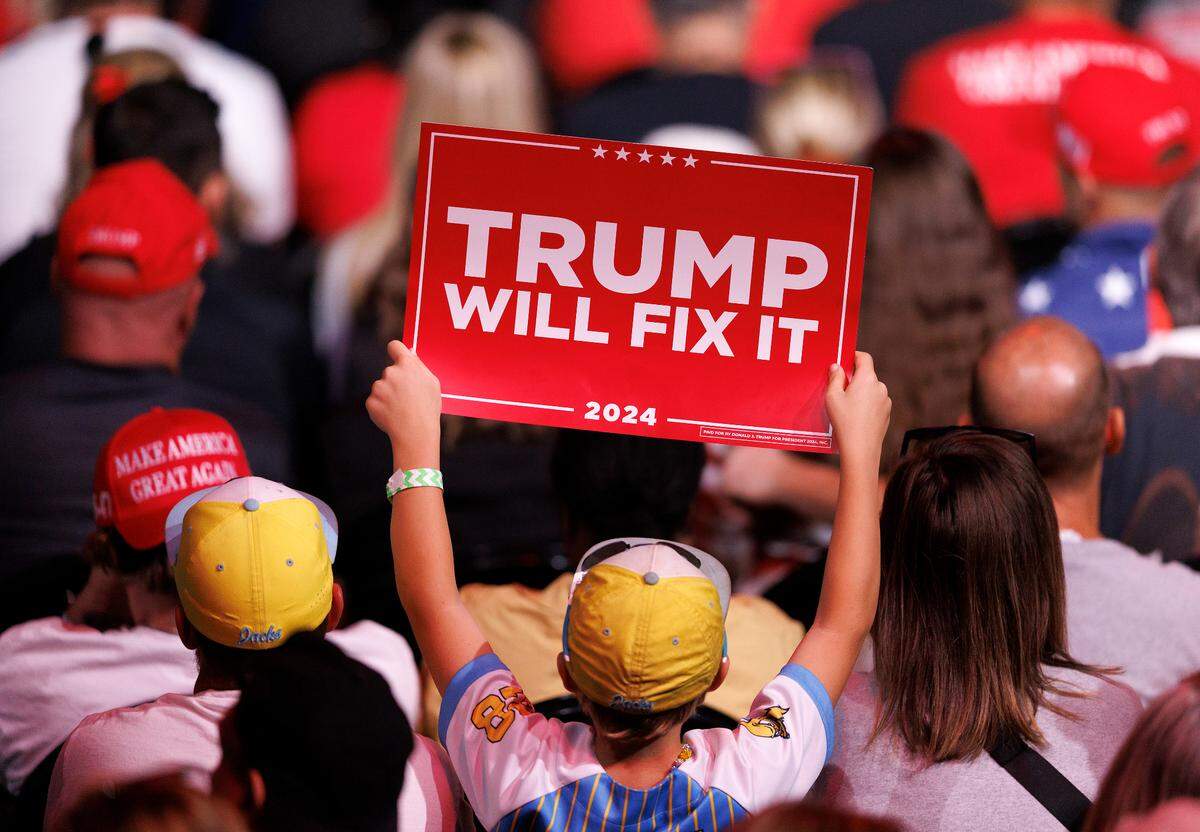 A supporter holds a sign as former Florida Attorney General Pam Bondi speaks during a campaign rally in support of former President and Republican presidential candidate Donald Trump at First Horizon Coliseum in Greensboro, N.C. on Saturday, Nov. 2, 2024.