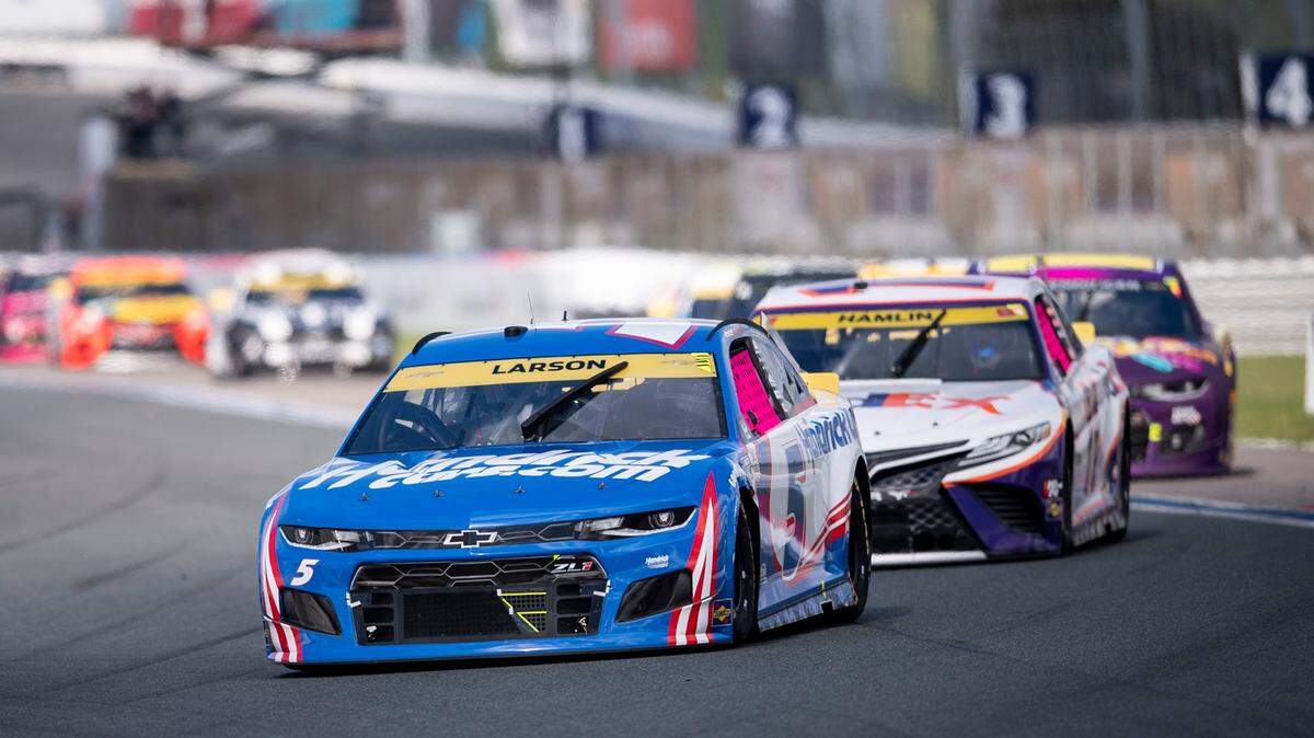 Kyle Larson (5) leads a pack of cars during a NASCAR Cup Series auto racing race at Charlotte Motor Speedway, Sunday, Oct. 10, 2021, in Concord, N.C. (AP Photo/Matt Kelley)