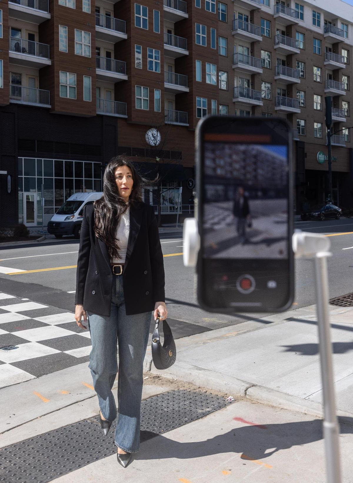 Charlotte influencer, Sydney Bernhardt, films content for her TikTok in Uptown in Charlotte, N.C., on Monday, March 4, 2024.
