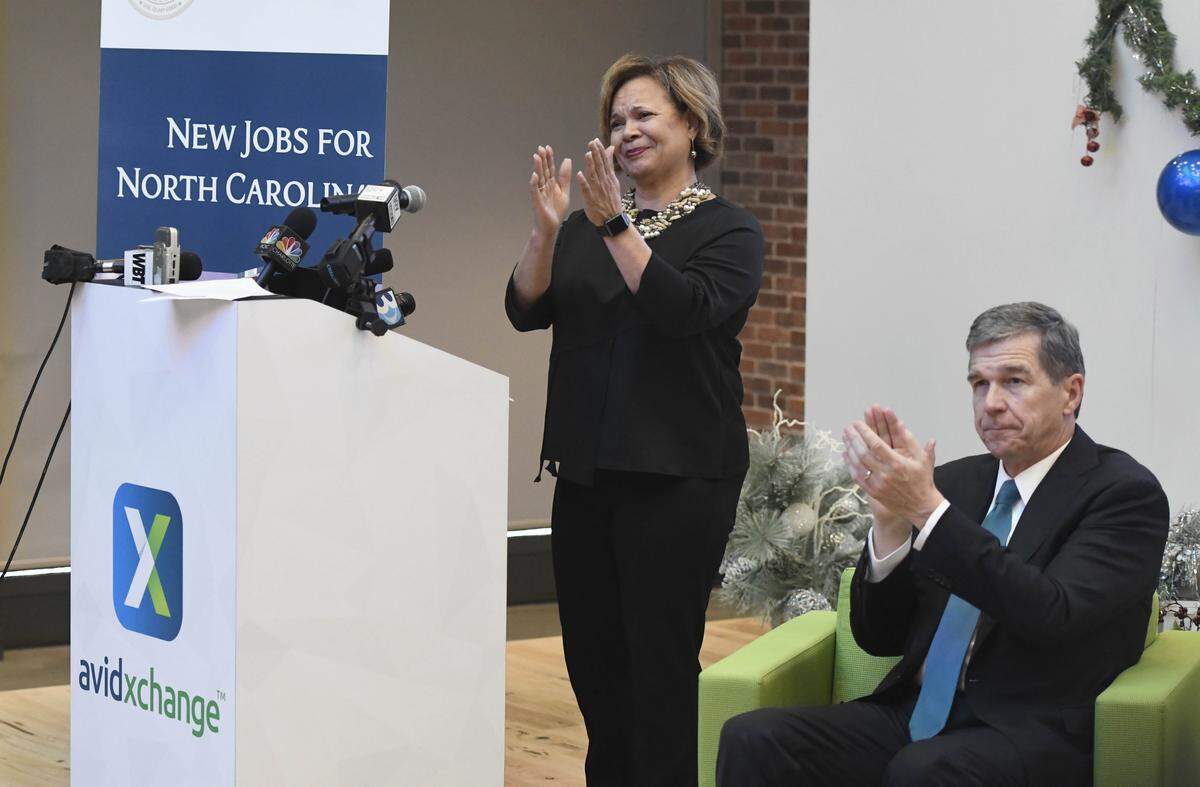 Charlotte Mayor Vi Lyles, standing and NC Gov. Roy Cooper applauds the employees of AvidXchange during an announcement of the company's expansion in its Charlotte Headquarters and the addition of over 1,200 new jobs, on Tuesday, December 18, 2018.