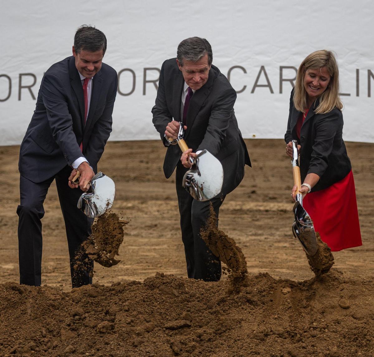 North Carolina Governor Roy Cooper (center) participates in a groundbreaking ceremony alongside members of local government and the CEO of Eli Lilly and Company, Dave Ricks (left) at the planned site for a new pharmaceutical manufacturing plant in Concord, Tuesday June 14, 2022