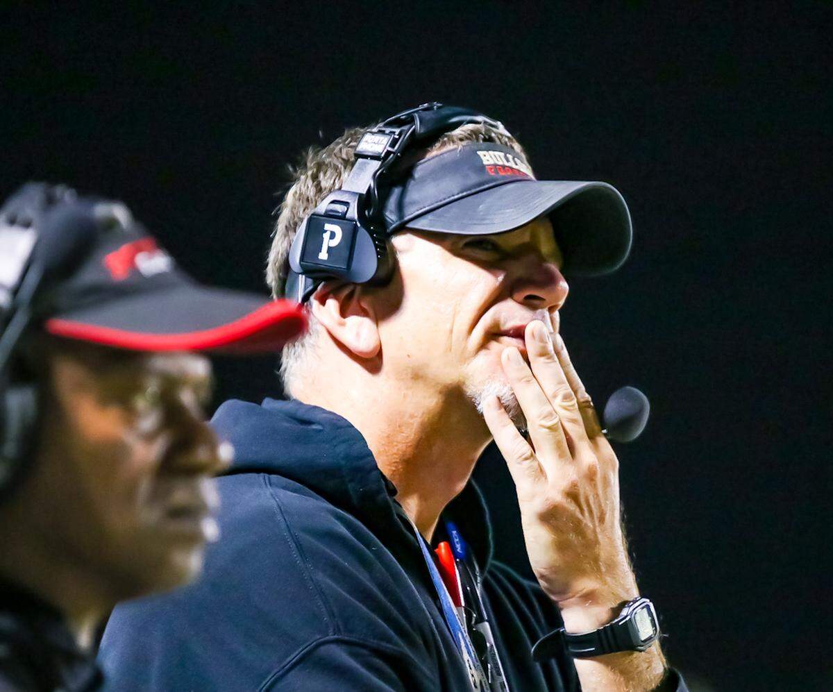 Butler Head Coach Brian Hales looks to the field to watch his team attempt to score