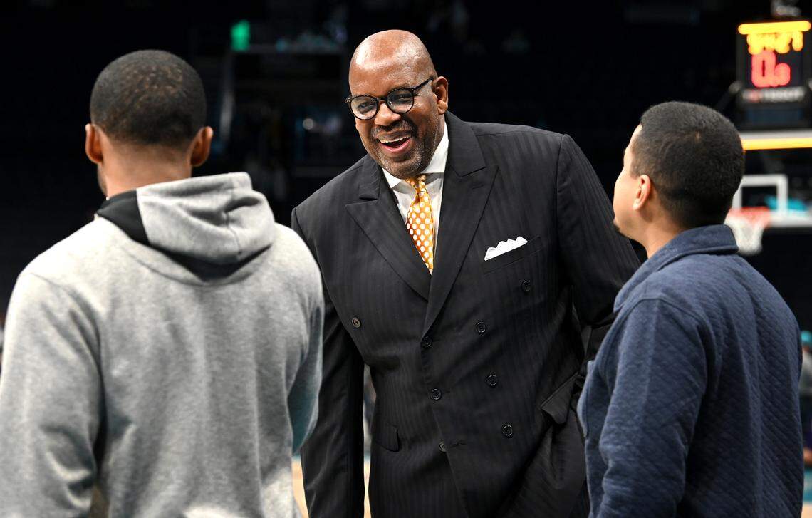 Former NBA star Cedric Maxwell, center, jokes with people along the Boston Celtics bench prior to the team’s game against the Charlotte Hornets at Spectrum Center in Charlotte, NC on Monday, January 16, 2023. Maxwell starred in the NBA for the Boston Celtics, Houston Rockets and Los Angeles Clippers. Maxwell now works in radio broadcasting announcing Celtics games.