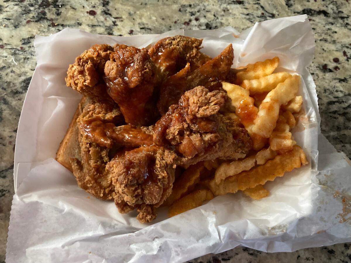 A four-piece dinner and fries with mild sauce from Harold’s Chicken & Ice Bar.