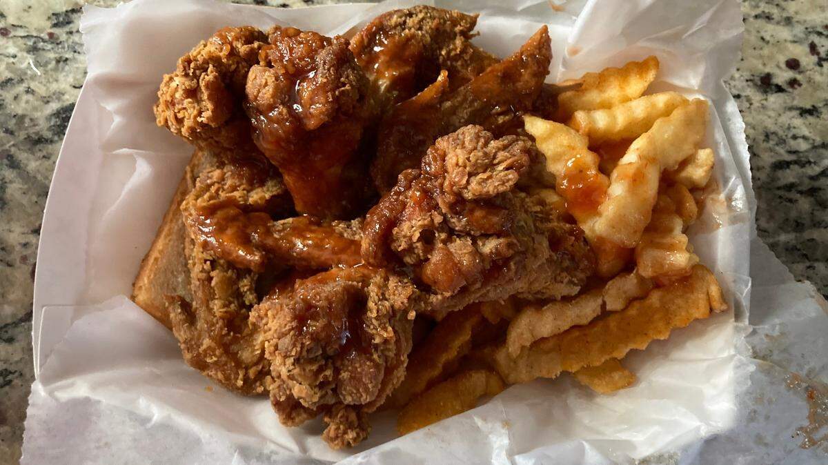A four-piece dinner and fries with mild sauce from Harold’s Chicken & Ice Bar.