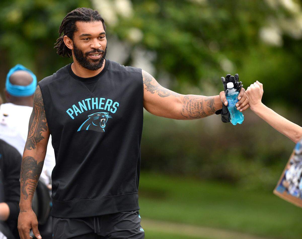 Fans weren't the only ones ready to fist-bump Carolina Panthers defensive end Julius Peppers, who's back for a 17th NFL season. New defensive coordinator Eric Washington was pleased, too.