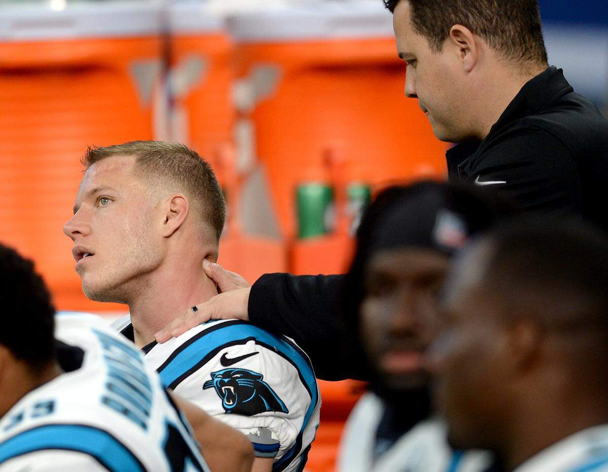 Panthers running back Christian McCaffrey, left, has his neck worked on during the Indianapolis game Dec. 22nd. McCaffrey’s heavy workload has been a source of concern.
