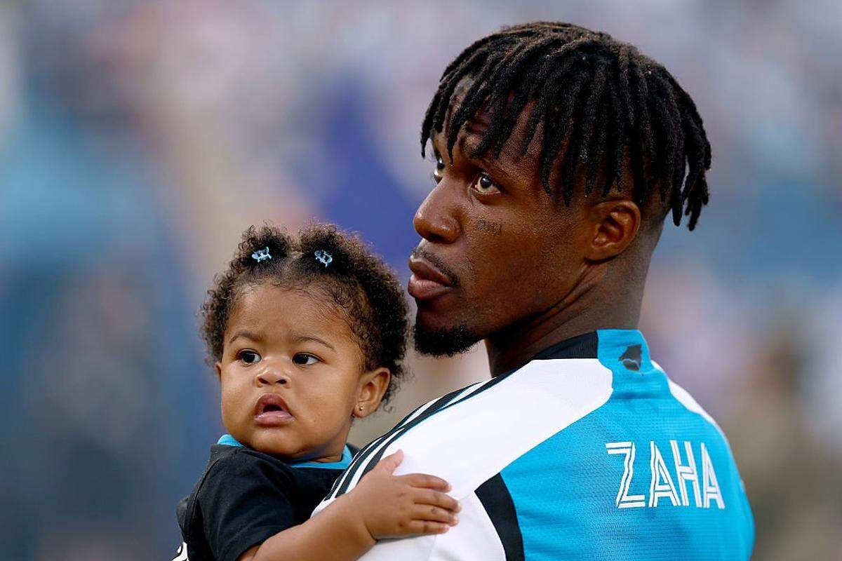 CHARLOTTE, NORTH CAROLINA - OCTOBER 18:  Wilfried Zaha #10 of Charlotte FC stands with his daughter during the national anthem prior to the MLS match against Philadelphia Union at Bank of America Stadium on October 18, 2025 in Charlotte, North Carolina. (Photo by Grant Halverson/Getty Images)