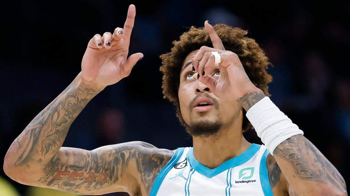Charlotte Hornets guard Kelly Oubre Jr. (12) motions to the sky after a basket during a game against the Sacramento Kings at Spectrum Center in Charlotte, N.C., Monday, Oct. 31, 2022.