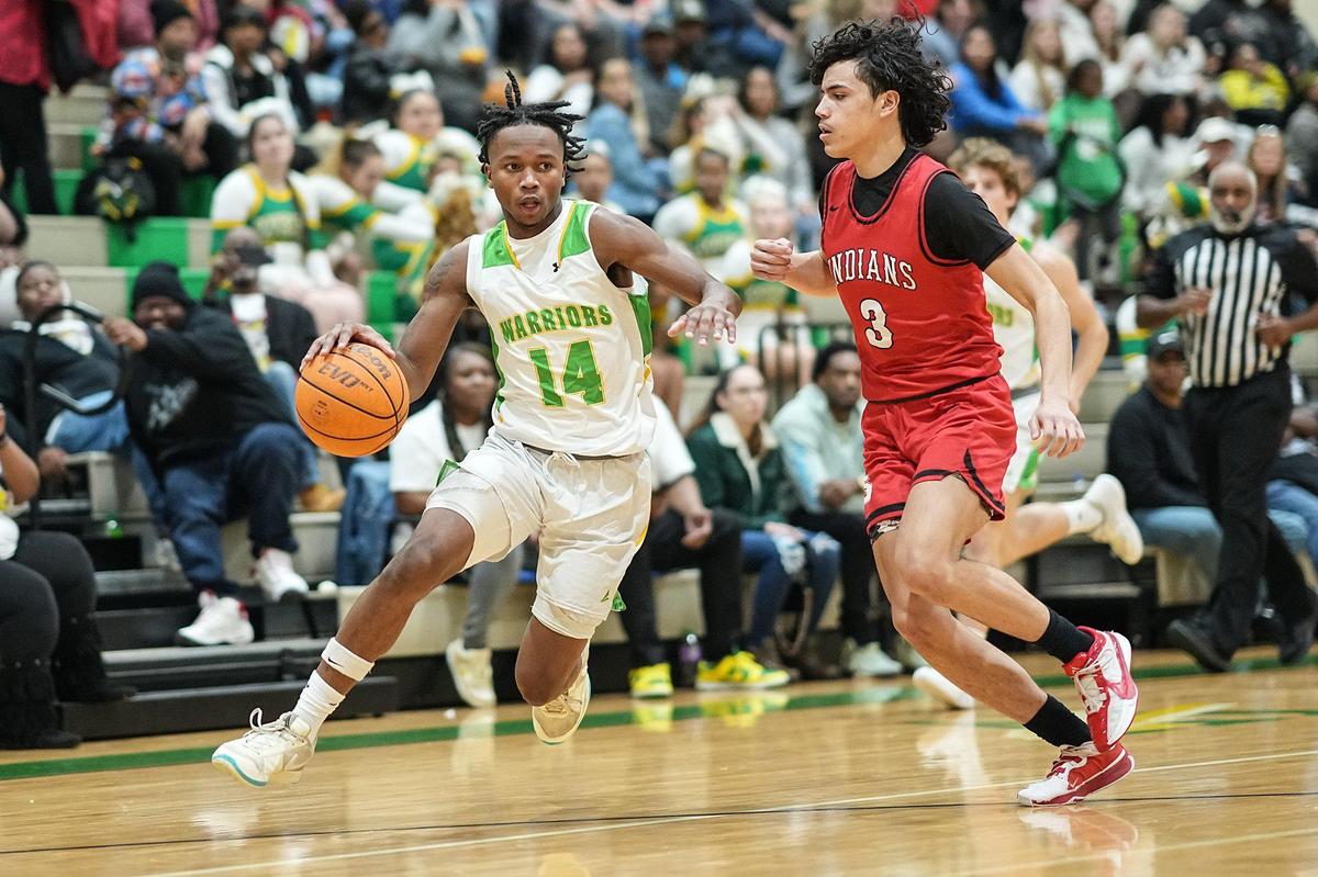 West Iredell’s Jordan Patterson (14) drives past St. Stephens’ Javian White (3) during the first half of a varsity basketball game Friday, Dec. 20, 2024, in Statesville, N.C. (Charlotte Observer /Matt Kelley)