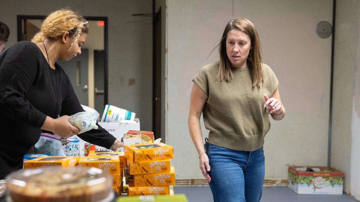 Kayla Neal, left, and Caris Malone organize food donations at Tabernaculo de Garcia in Charlotte, N.C., on Tuesday, November 25, 2025.