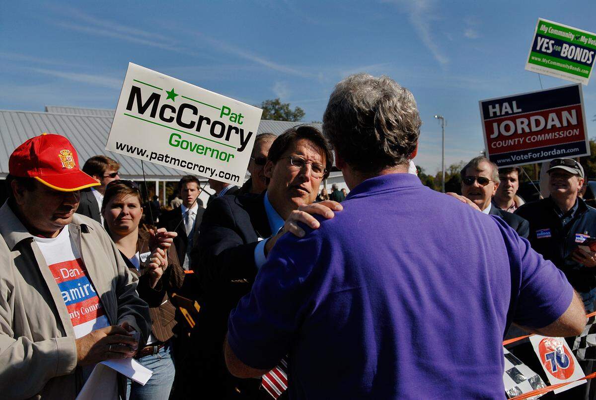 Pat McCrory, Charlotte mayor and NC gubenatorial candidate, greets longtime political acquaintance, Jeff Williams at the Mallard Creek Barbecue Thursday, Oct. 23, 2008.