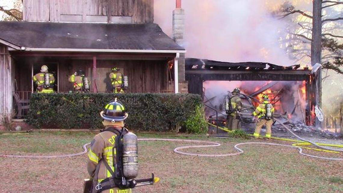 Firefighters attack flames on Friday. Nov. 26, 2021, at the Concord NC home of Jim Avett, father of Scott and Seth Avett of the Avett Brothers band.