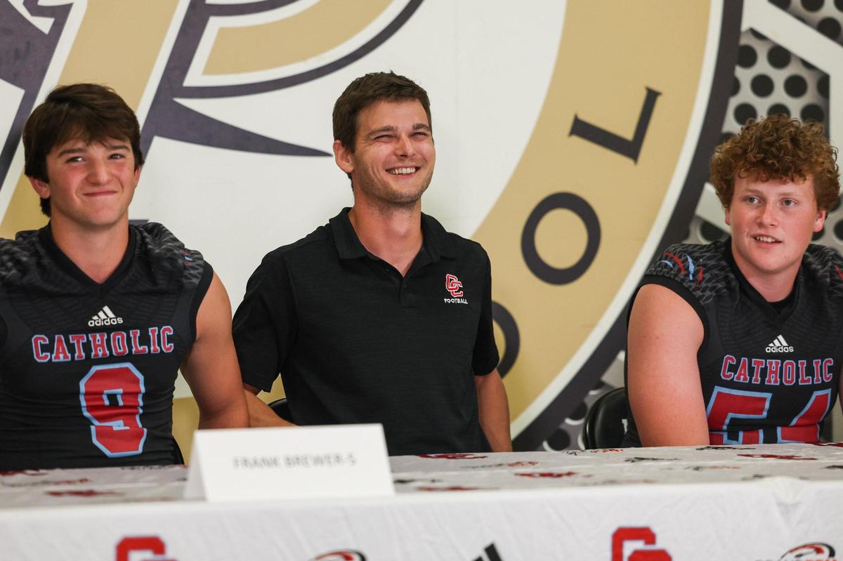 Charlotte Catholic head coach Matt Reilly, center, laughs during Southwestern 4A media day at Providence High School on Thursday, July 27, 2023 in Charlotte, NC.