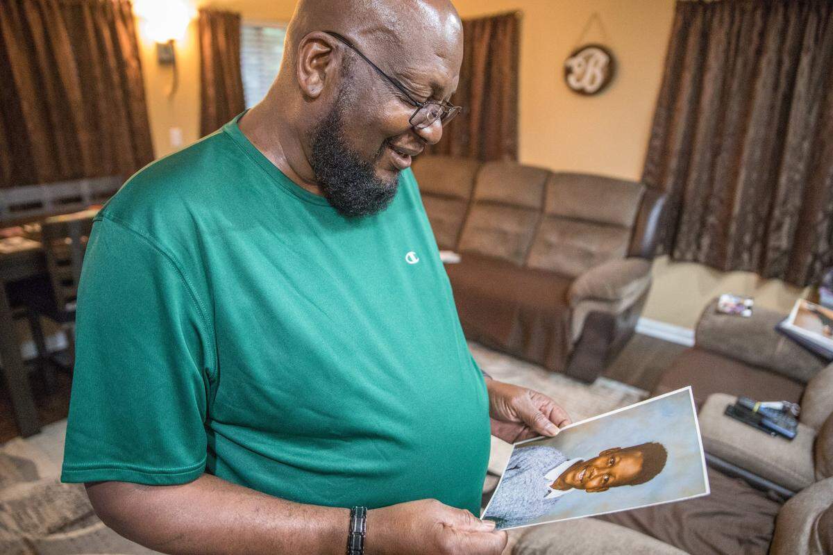 Charles Billings, father of Juneteenth shooting victim Jamaa Cassell, views a photo of his son.