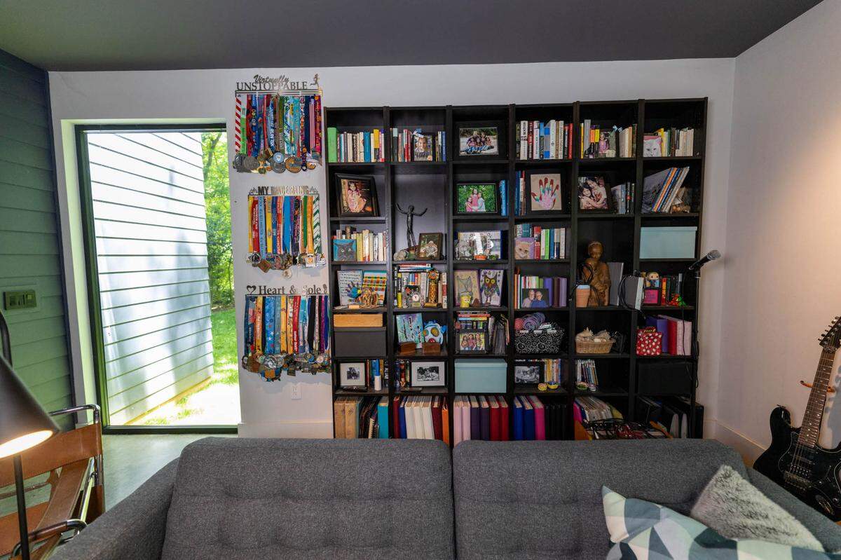 Cube shelving in the back of the living room holds photos, books and awards.