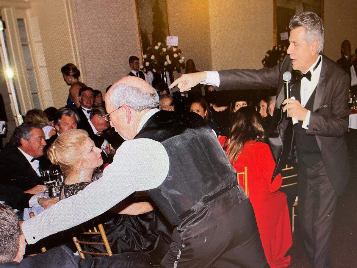 Ernest Perry and Larry Sprinkle work an auction for the Allegro Foundation.