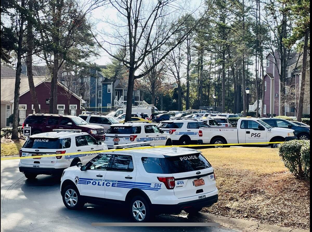 Charlotte-Mecklenburg police vehicles line the entrance at 6100 Treetop Court in Charlotte, NC on Monday, December 27, 2021. An officer was shot earlier Monday morning.