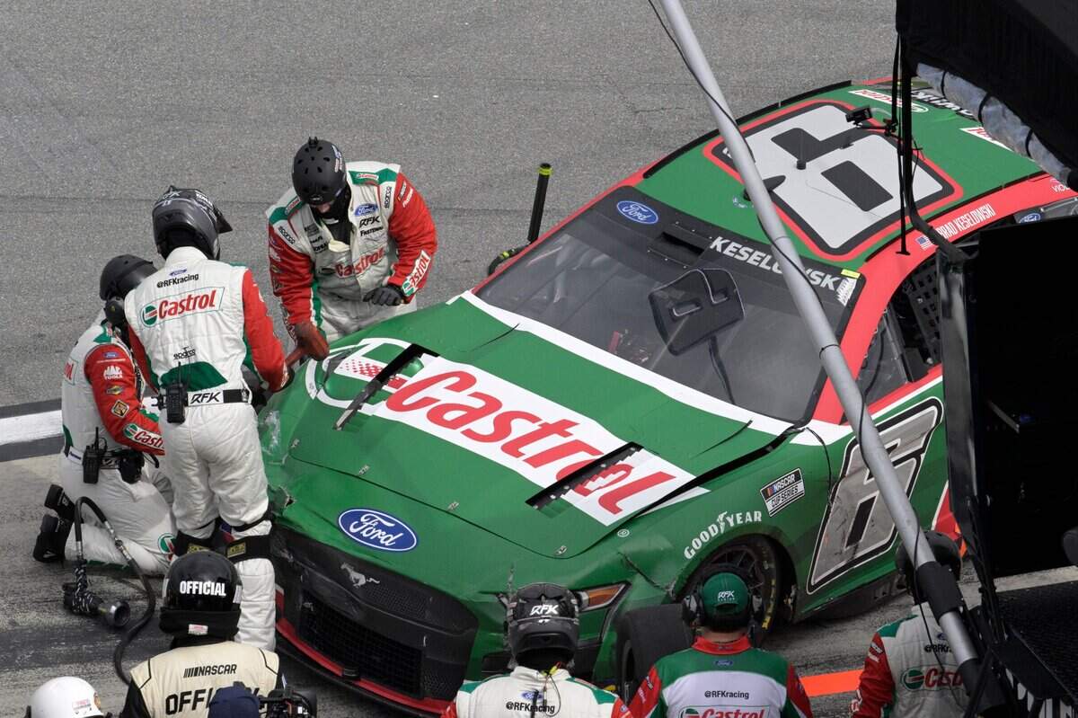 Crew members work on Brad Keselowski’s car after a wreck during a NASCAR Cup Series auto race at Daytona International Speedway, Sunday, Aug. 28, 2022, in Daytona Beach, Fla. (AP Photo/Phelan M. Ebenhack)
