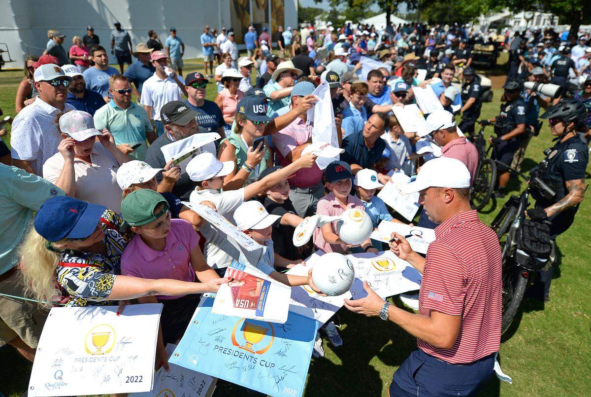 Justin Thomas, front/right, stops to sign autographs for fans following a practice round at Quail Hollow Club in Charlotte, NC on Tuesday, September 20, 2022. Thomas is playing on the U.S. Team in the Presidents Cup. The Presidents Cup will be held at Quail Hollow Club from September 22-25, 2022.