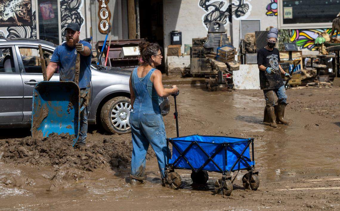 Residents and volunteers clean up on Tuesday, Oct. 1, 2024 after the French Broad River flooded downtown Marshall. The remnants of Hurricane Helene caused widespread flooding, downed trees, and power outages in western North Carolina.