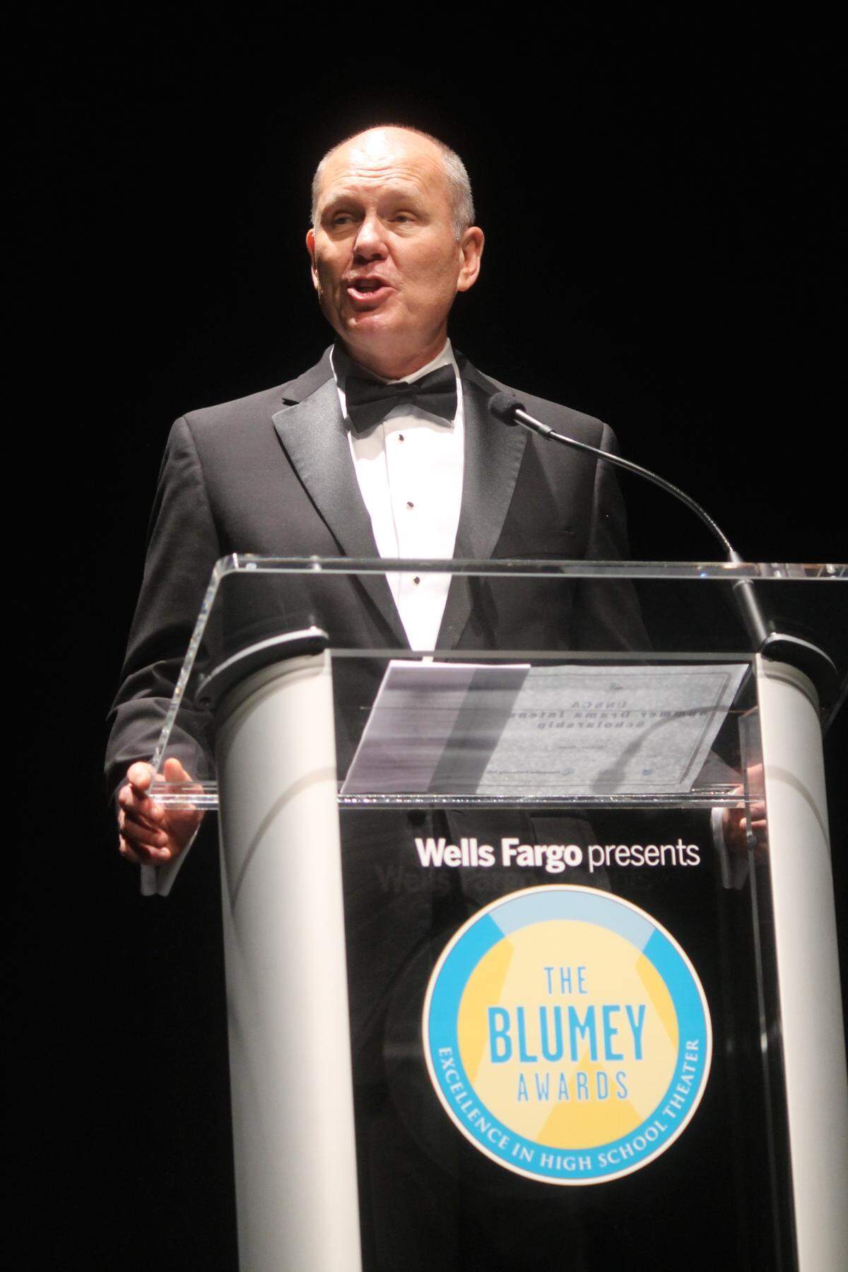 Ralph Beck presenting at a Blumey Awards ceremony in Charlotte. After attending the National High School Musical Theater Awards in New York, Beck started the Blumeys in Charlotte in 2012. The Blumeys are the local equivalent of the Tony Awards for high school students.