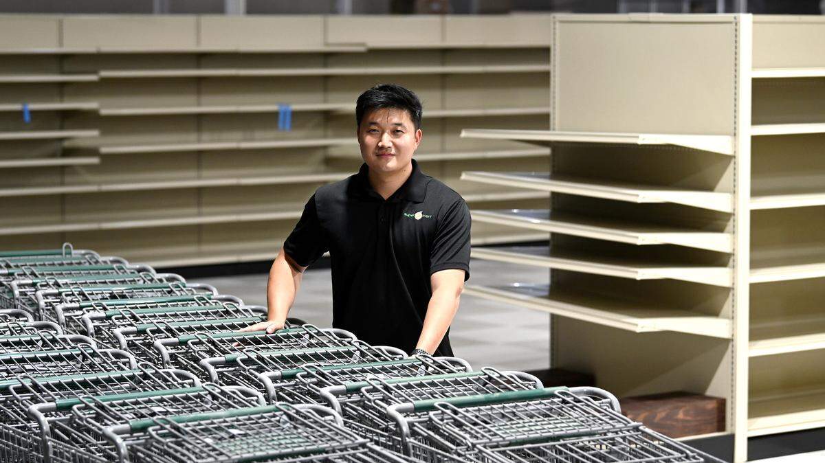 Peter Han stands at the new Super G Mat in Pineville. The Han family owns and runs the Super G Mart.