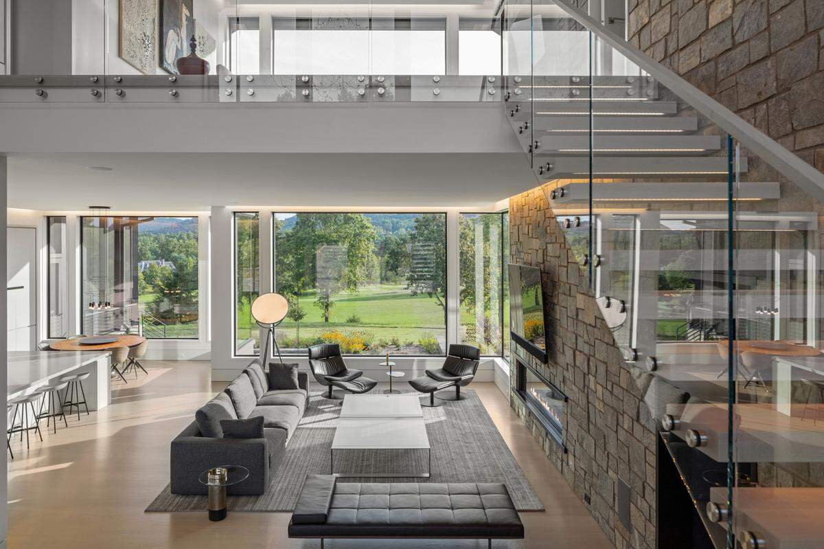 The main floor includes the primary bedroom suite, thoughtfully designed with a generous walk-in closet, a custom primary bath suite, and a personal sitting room.