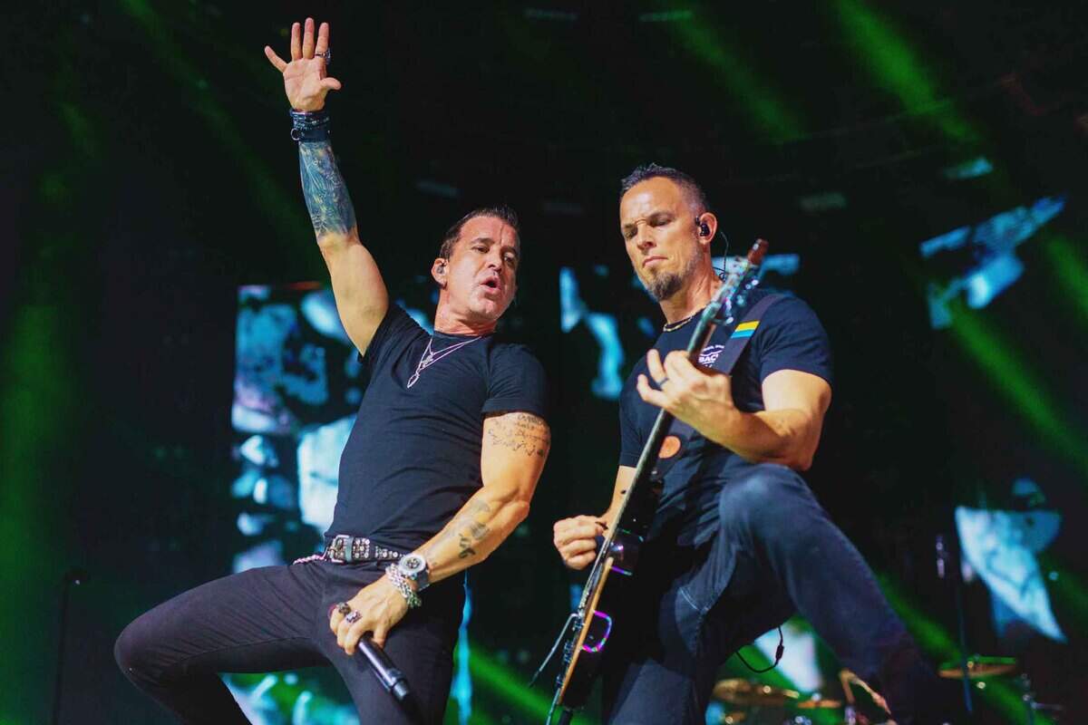 Lead singer Scott Stapp (left) and guitarist Mark Tremonti of Creed perform with the band at PNC Music Pavilion in Charlotte on Friday night.