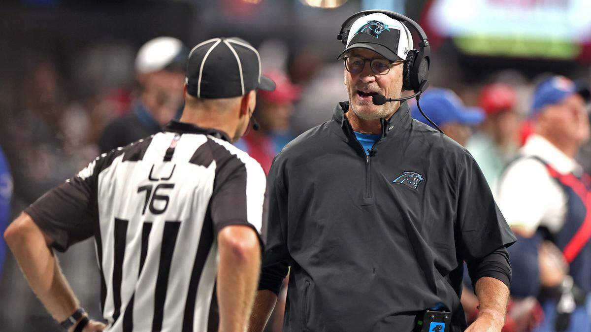 Carolina Panthers head coach Frank Reich, right, walks down the sideline to speak with line judge, left, during fourth-quarter action against the Atlanta Falcons at Mercedes-Benz Stadium in Atlanta, GA on Sunday, September 10, 2023. The Falcons defeated the Panthers 24-10.