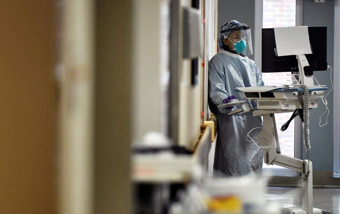 A nurse works from a mobile computer station outside of a Covid patient’s room at UNC Hospital in Chapel Hill, N.C. Thursday, Nov. 26, 2020.