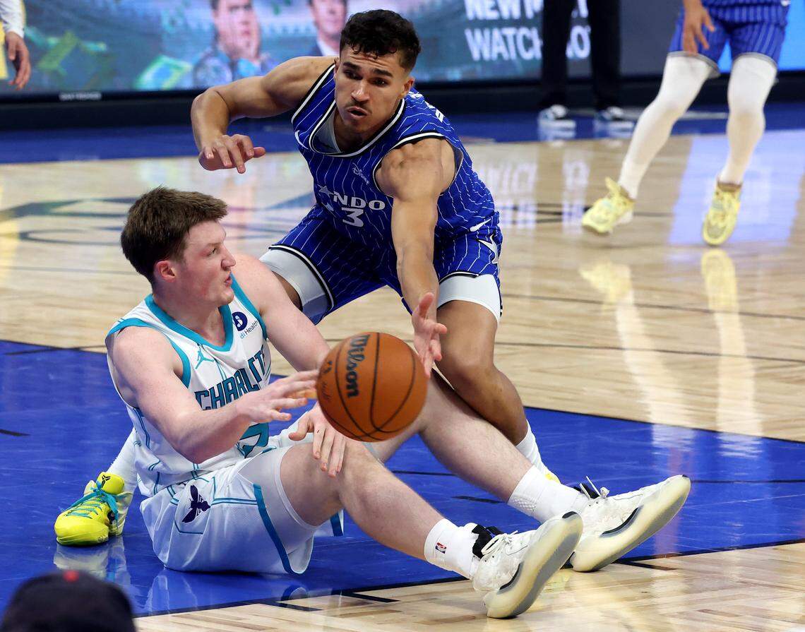 Charlotte Hornets forward Kon Knueppel, left, passes to a teammate after grabbing control of a loose ball as Orlando Magic forward Tristan da Silva, right, applies pressure during action at Kia Center in Orlando, FL on Friday, April 17, 2026.