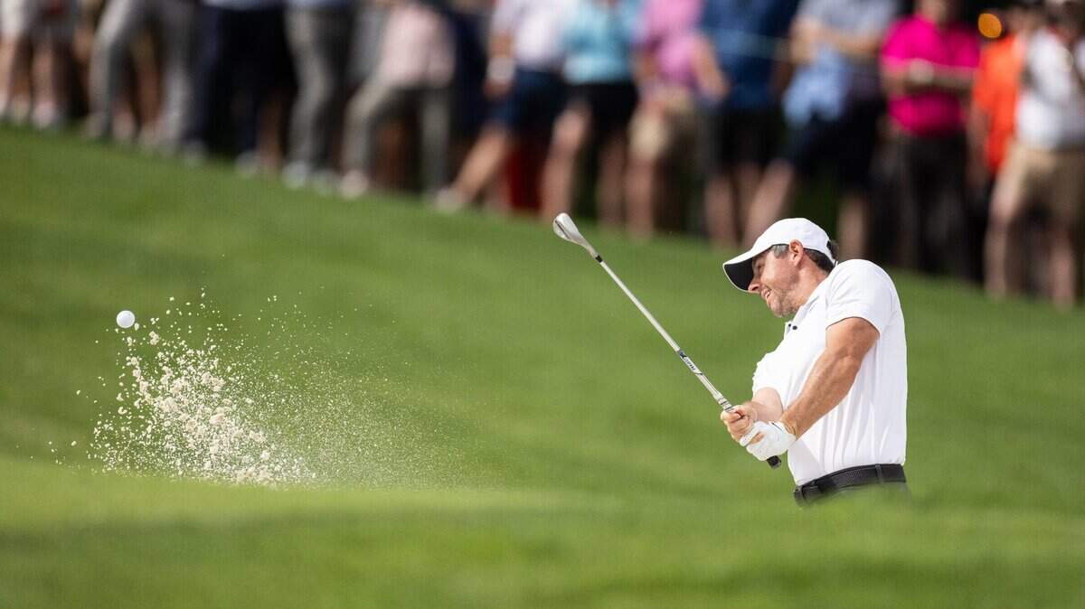 Rory McIlroy hits out of a bunker on the 10th hole during round one of the Wells Fargo Championship at Quail Hollow Club in Charlotte, N.C., on Thursday, May 9, 2024.