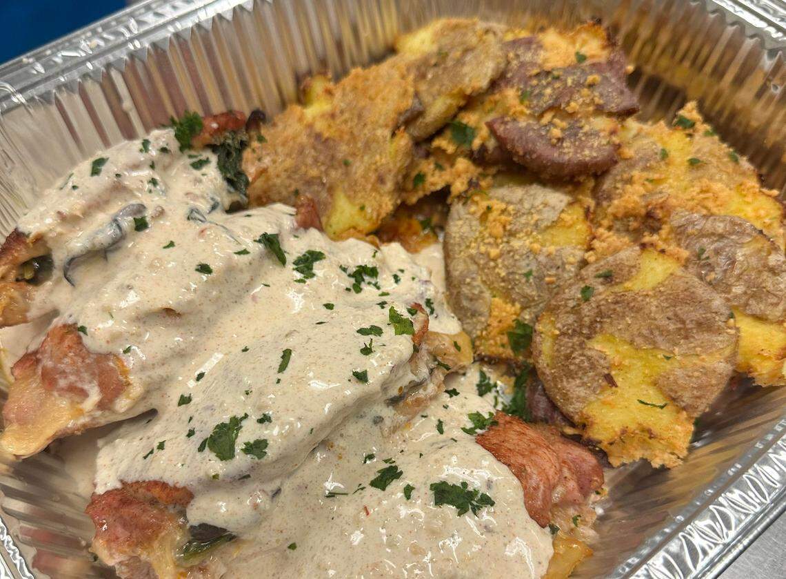 SplenDishes offers a meal with garlic mushroom and spinach stuffed pork chops with parmesan cream sauce and smashed potatoes.