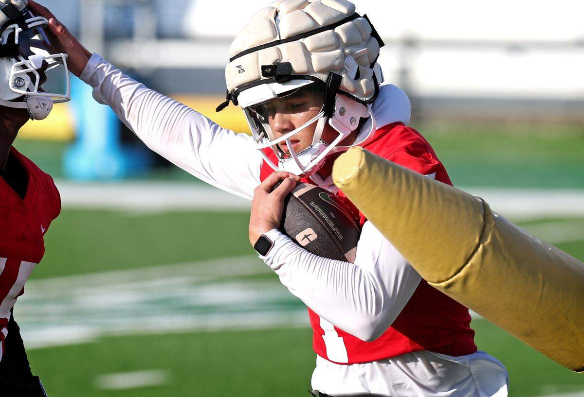 Charlotte 49ers quarterback Max Brown rushes through a blocking drill during the team’s first summer training camp practice on Friday, August 3, 2024.