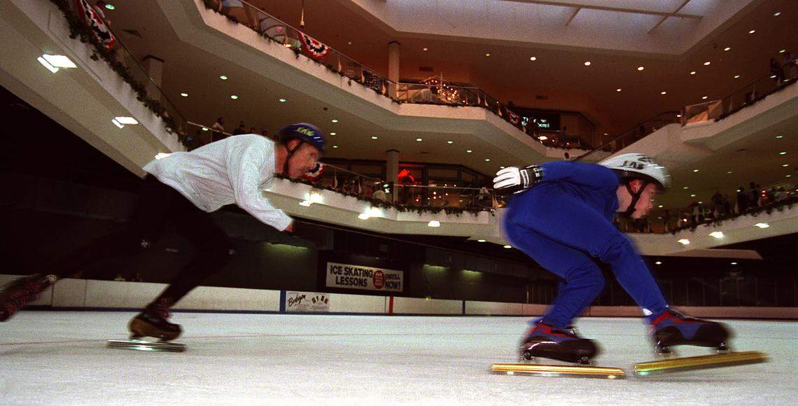 2/9/02: 10-year-old Robert Lawrence (right) skates laps round the ice rink at Eastland Mall Saturday afternoon, followed closely by his unofficial coach, 61-year-old Bob Fisher. Robert Lawrence's nickname is Roborunt. He's a national champion speed skater who's just 10 years old and one of the few members of a speed skating club based in Charlotte that draws members from South Carolina and Tennessee. His unofficial coach, 61-year-old Bob Fisher, is a speed skater champion himself. NORMAN NG-STAFF