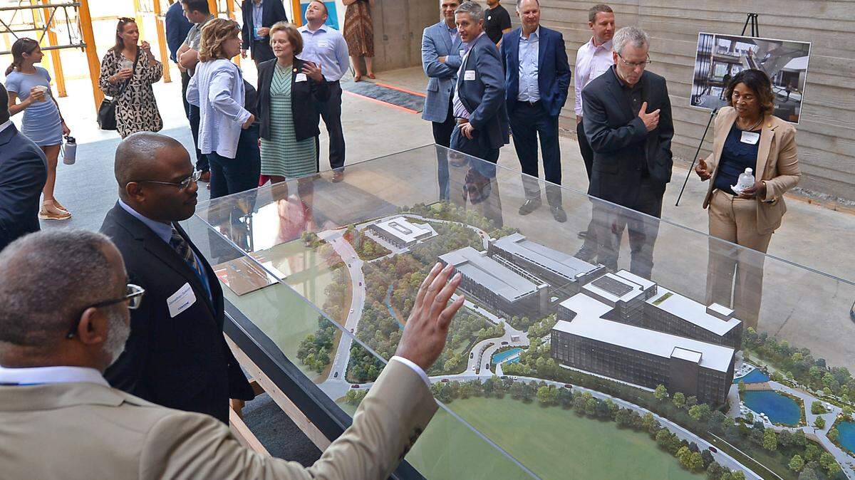 Guests check out the model of Centene Corp. East Coast headquarters campus plans under construction at University City Research Park in Charlotte in this 2021 file photo. Centene confirmed it now no longer is coming to Charlotte.