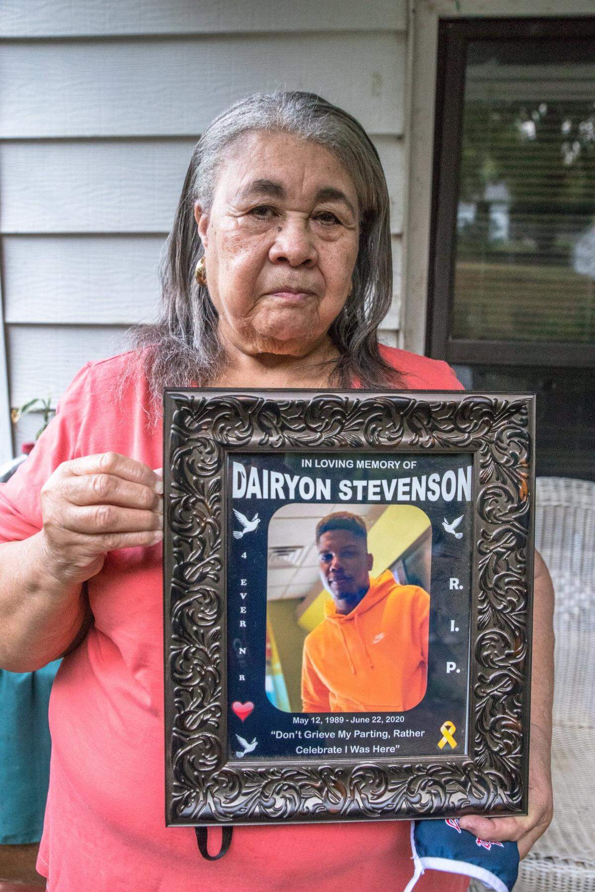 Rosa Stevenson, grandmother of Juneteenth shooting victim Dairyon Stevenson, holds an image of her grandson.